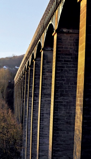 View from beneath the aqueduct's trough looking down the line of towering stone piers