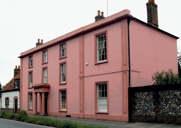 Grade II listed building with facade, portico and return elevation painted dark pink