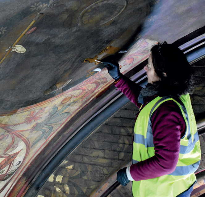 A conservator reducing the layers of varnish