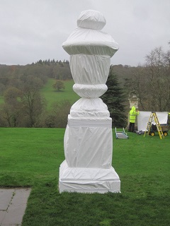 Marble garden sculpture tightly wrapped for the winter in waterproof but vapour-permeable sheeting