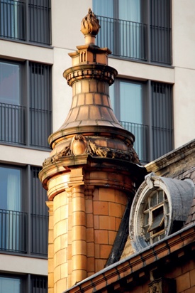 Terracotta-clad finial topped by flaming torch motif