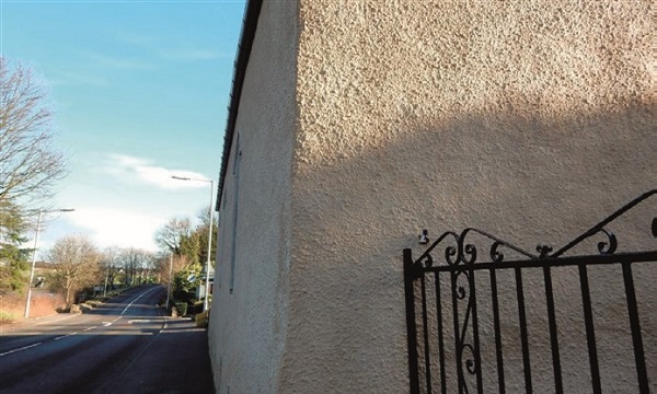 A north-facing roadside elevation on a busy street