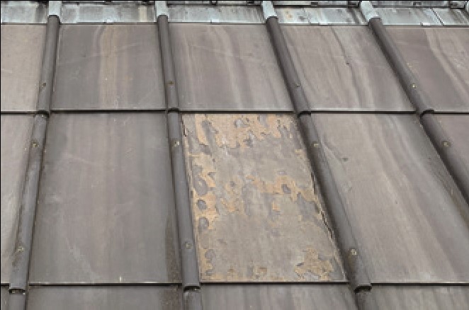 A close-up of older and newer slates on the repaired roof