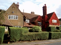 Pair of pebbledashed semi-detached houses in Arts & Crafts style