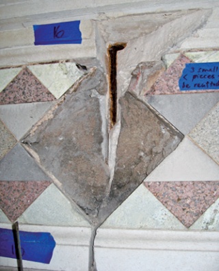 Corroded iron cramp exposed by removal of tilework