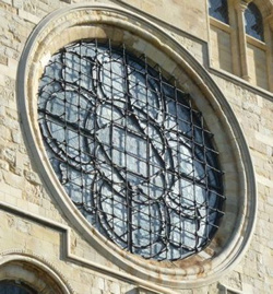 Exterior of oculus window with visually obtrusive iron grille