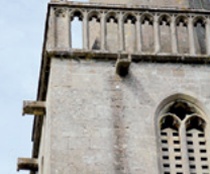 U-section stone rainwater chutes below gothic tower balustrade