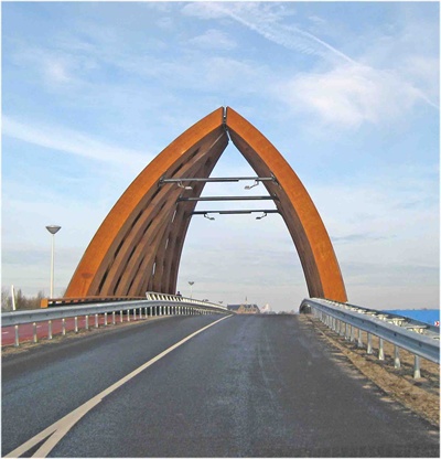 The triangular overhead trusses of a modern timber road bridge