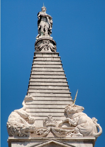 Tower of St George's, Bloomsbury, which takes the form of a stepped pyramid and is decorated with a lion, a unicorn and a crown at its base and is surmounted by a statue of George I dressed as a Roman emperor