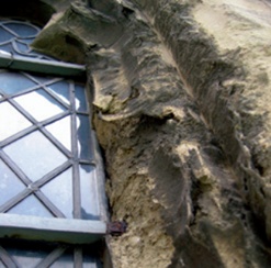 Spalling masonry around rust damaged glazing bar