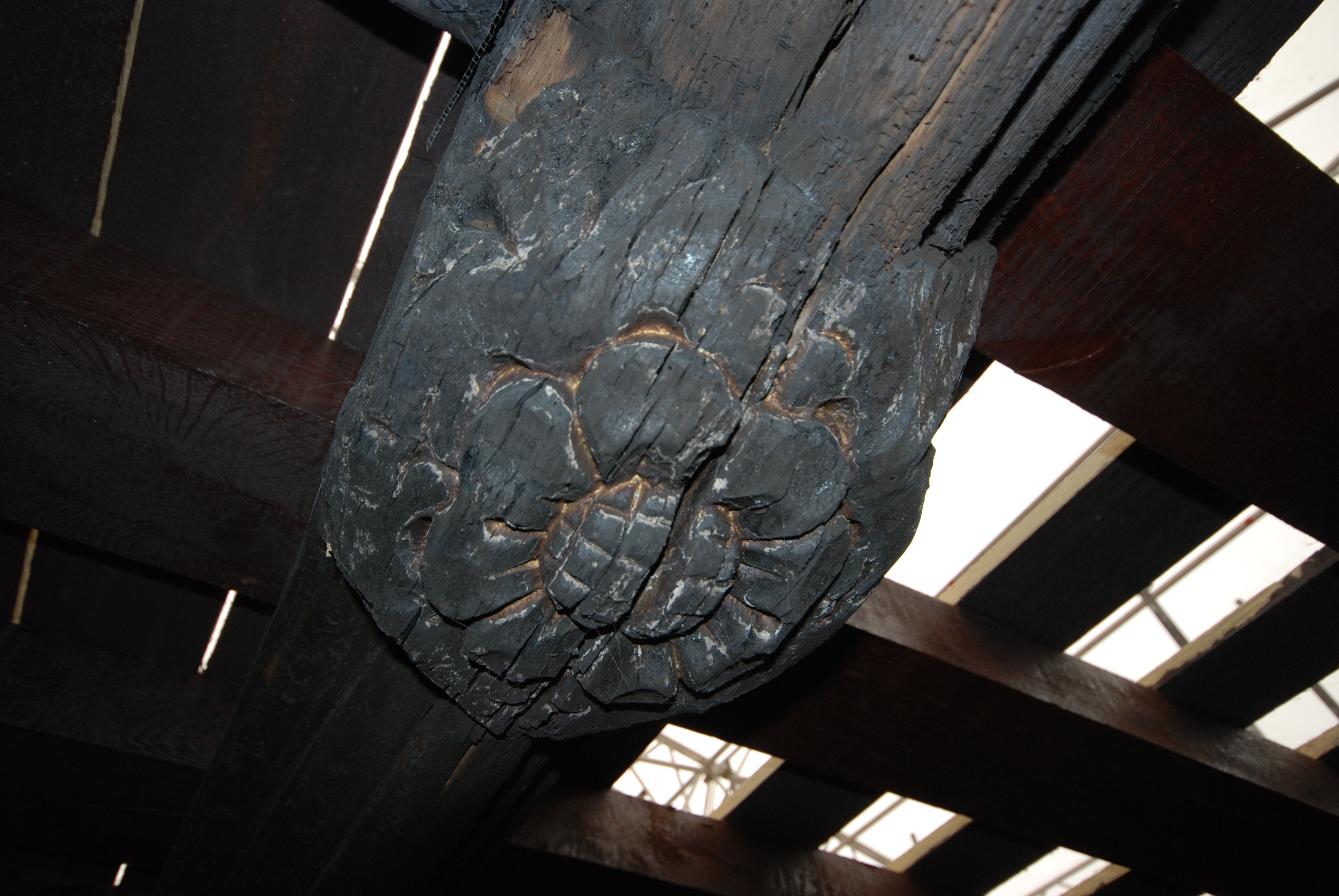 Charred surface of a boss from the ceiling of the nave