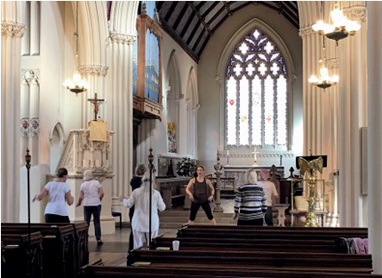 Zumba class in progress with altar and east window in background