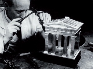 Black & white photograph of craftsman working on a silver model of the Euston Arch