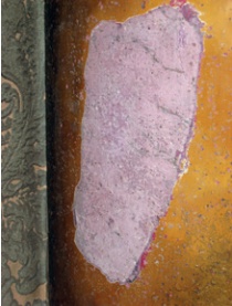Area of exposed pink scagliola surrounded by later overpainting