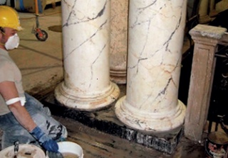 A conservator cleans a pair of Marezzo columns