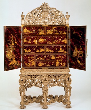 Stunning Japanned cabinet with doors open to reveal draw fronts decorated in oriental style with birds, plants, pagodas, etc in gold on background of deep reds and blacks resembling tortoiseshell