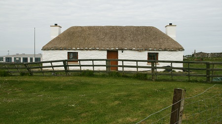 A cottage on the Isle of Benbecula re-thatched using marram swept over the ridge