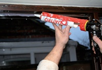 Contractor applying rubber polymer sealant