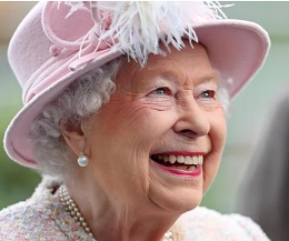 Queen Elizabeth the second in a pink hat